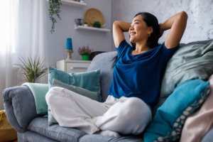 happy young woman sitting on the cozy