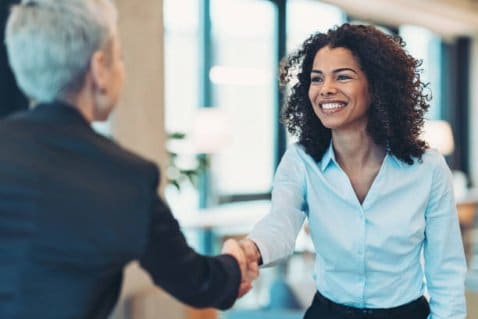 Businesswomen shaking hands in the office